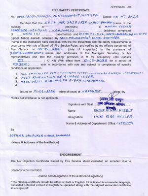 Fire safety certificate page with blue stamps and signatures on white paper; form text is partially legible.